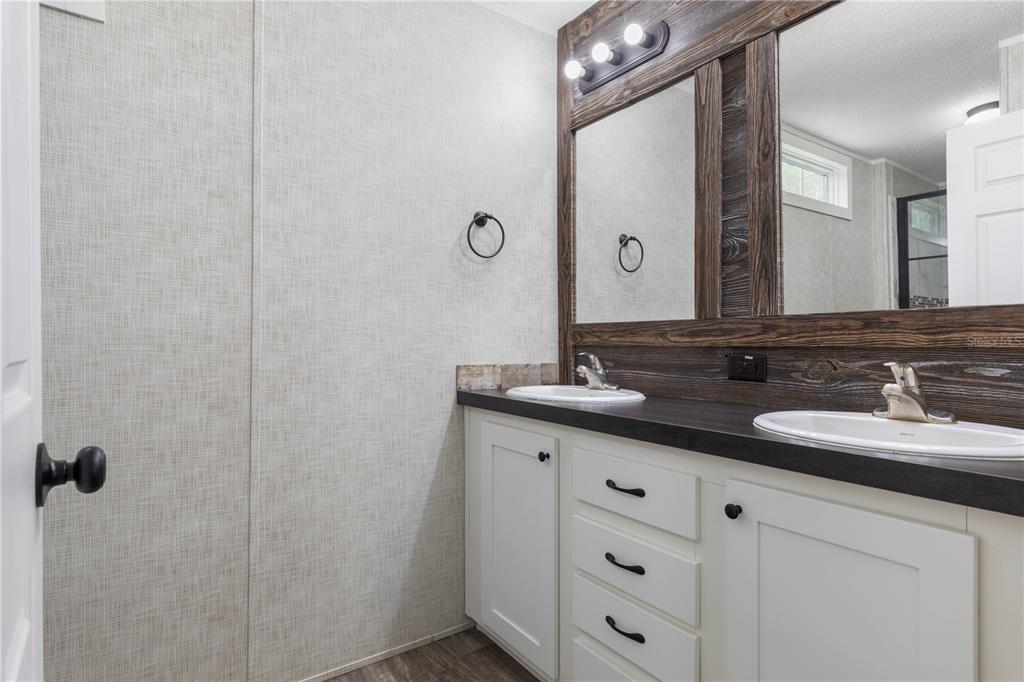 1688 Papaya Street Bunnell, FL 32110 - Photo 20 of 63 a bathroom with a double vanity sink and mirror