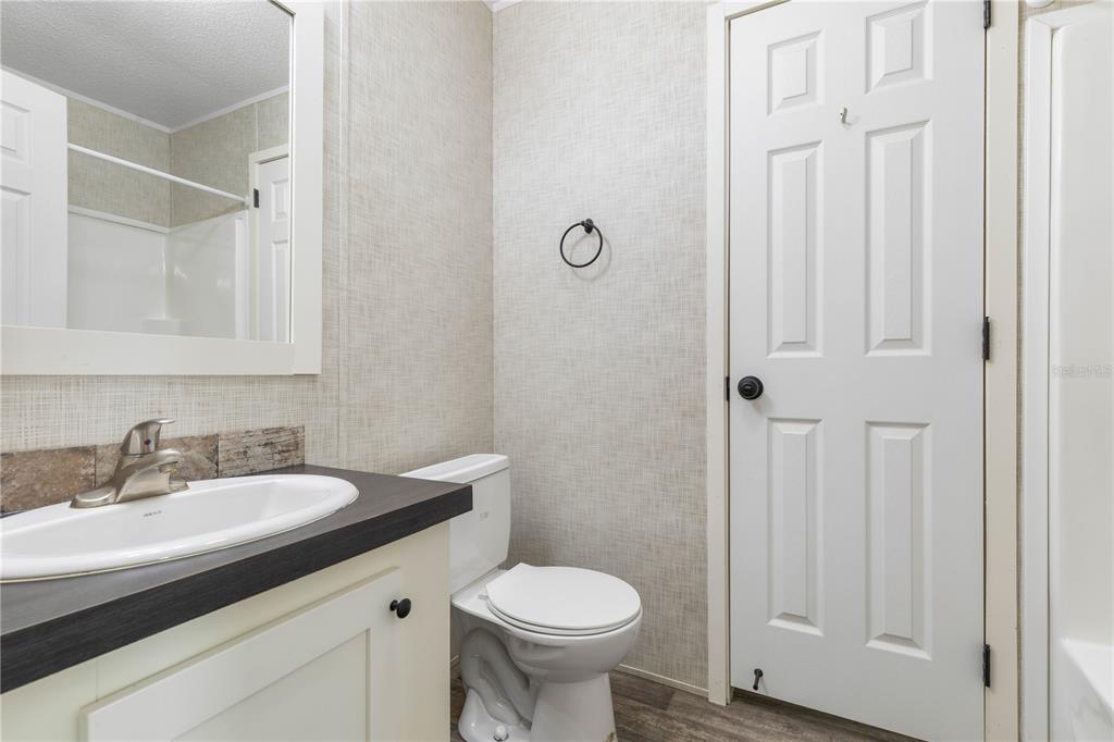 1688 Papaya Street Bunnell, FL 32110 - Photo 27 of 63 a bathroom with a sink toilet and a mirror