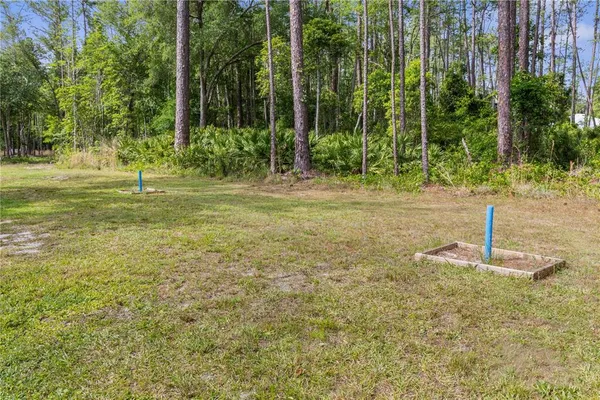 a backyard of a house with table and chairs