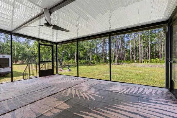 a view of a deck with a big yard