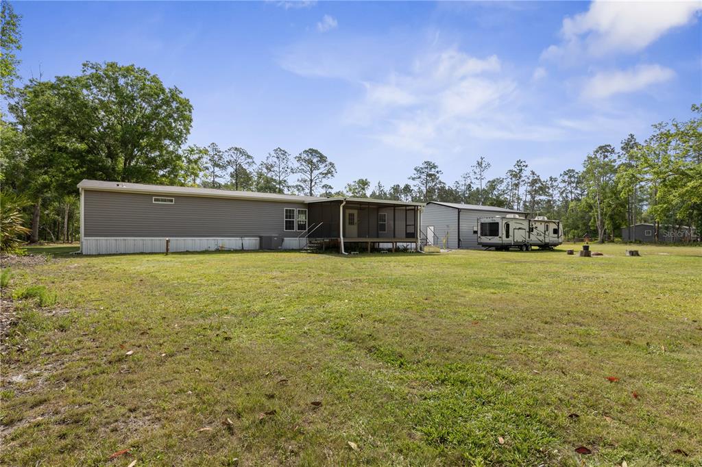 1688 Papaya Street Bunnell, FL 32110 - Photo 41 of 63 a view of a house with a yard