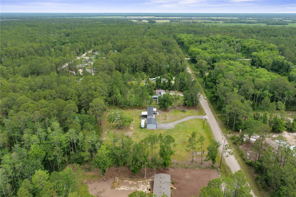 1688 Papaya Street Bunnell, FL 32110 - Photo 50 of 63 a view of a lake with a yard