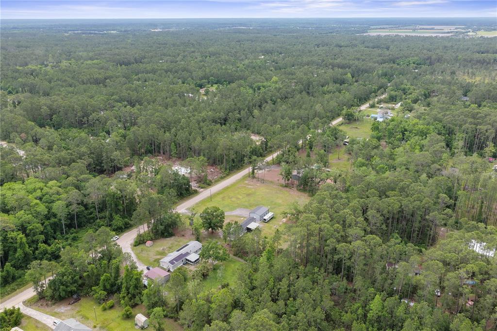 1688 Papaya Street Bunnell, FL 32110 - Photo 53 of 63 an aerial view of residential houses with outdoor space and trees
