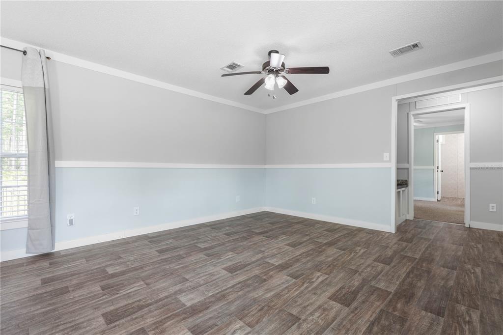1688 Papaya Street Bunnell, FL 32110 - Photo 9 of 63 wooden floor in an empty room with a window