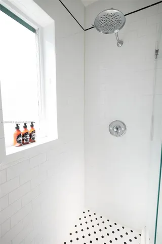 a spacious bedroom with a bed and wooden floor