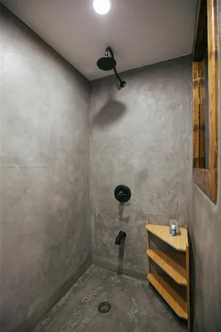 a living room with furniture a potted plant and a wooden floor