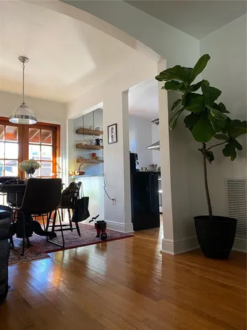 a view of a house with a yard and potted plants