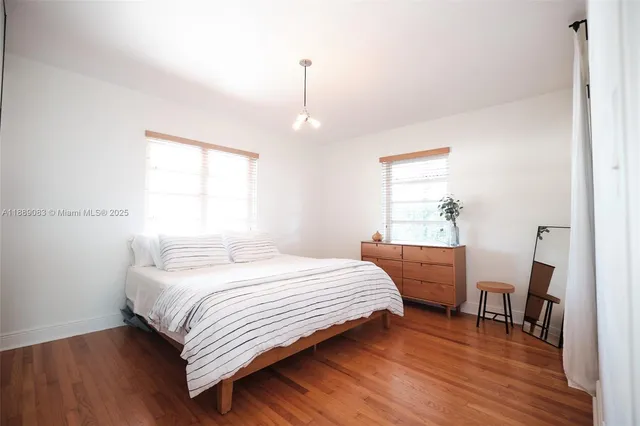 a living room with furniture a fireplace and a chandelier