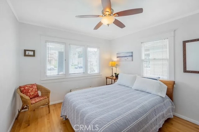 404 9th Street Huntington Beach, CA 92648 - Photo 15 of 19 a bedroom with a bed and a chandelier