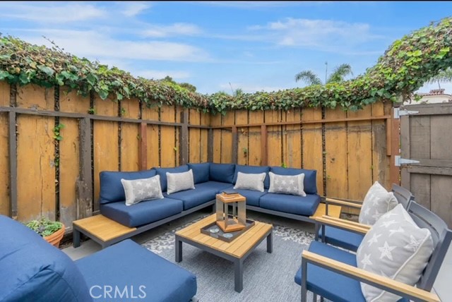 404 9th Street Huntington Beach, CA 92648 - Photo 19 of 19 a couch sitting in a living room next to a yard