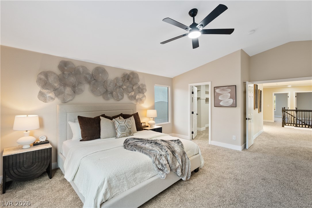 1662 Ravanusa Drive Henderson, NV 89052 - Photo 47 of 74 Relax in this inviting primary bedroom featuring vaulted ceilings and soft carpeting, perfect for a peaceful retreat.