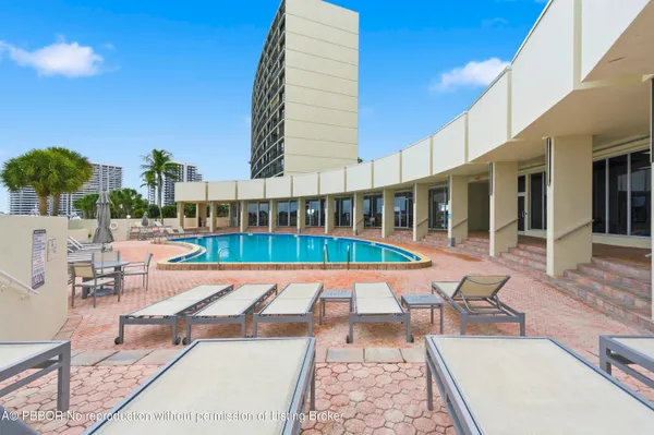 swimming pool with outdoor seating and yard