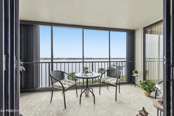 a view of a chairs and table in the balcony