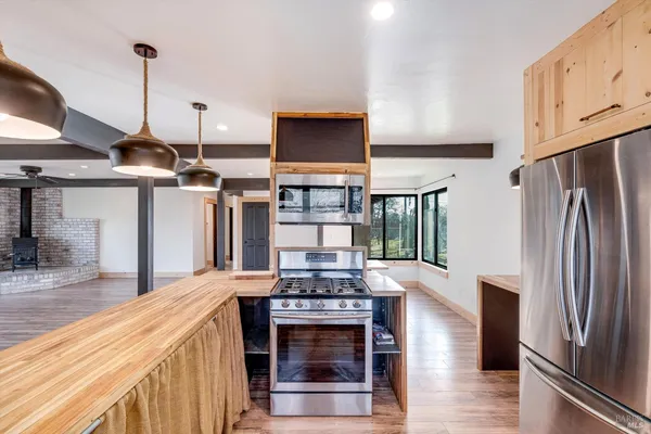 a kitchen with stainless steel appliances granite countertop a stove and a refrigerator