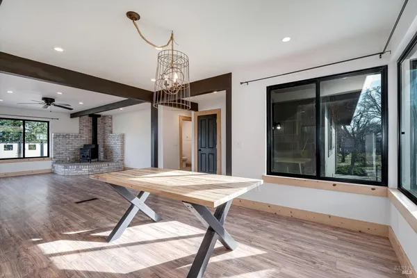 a view of a room with a table and chairs