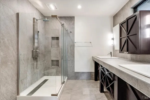 a bathroom with a sink a mirror and a shower