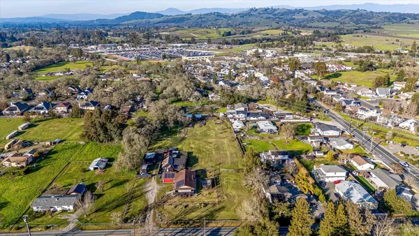 an aerial view of residential houses with outdoor space