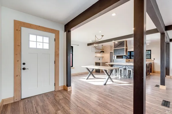 a view of a livingroom with furniture and kitchen view