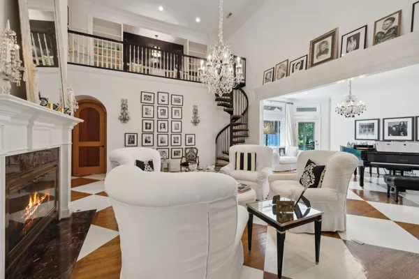 a living room with furniture a table and a large window