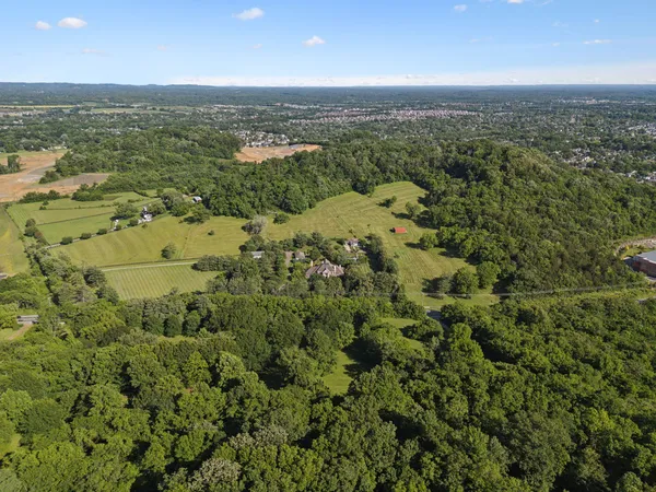 an aerial view of a houses with a yard