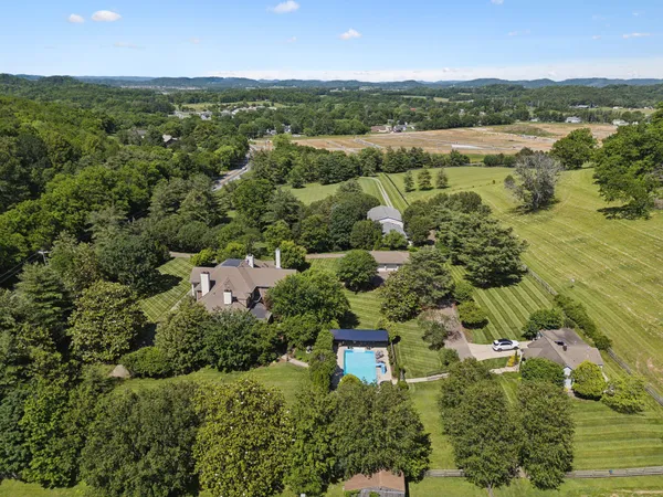an aerial view of a houses with a yard