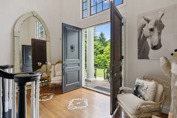 a view of entryway and hall with wooden floor