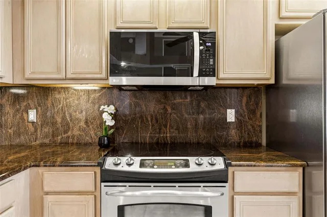 a kitchen with a sink cabinets and stainless steel appliances