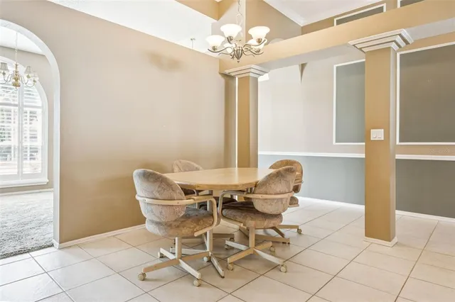 a view of a dining room with furniture and a chandelier