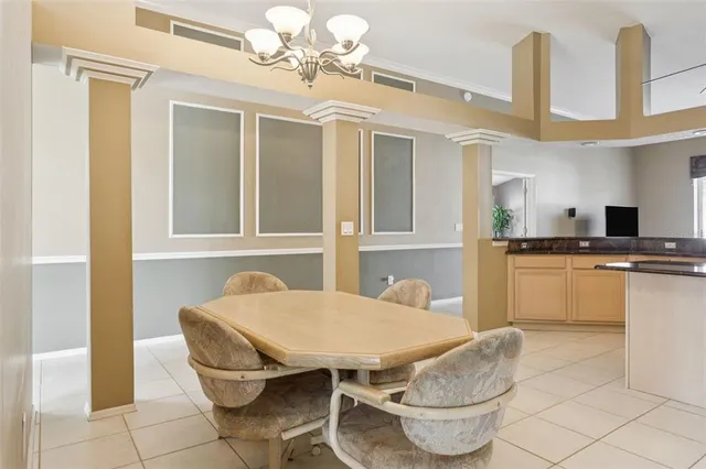 a kitchen with stainless steel appliances kitchen island granite countertop a refrigerator a stove a sink dishwasher a dining table and chairs with wooden floor