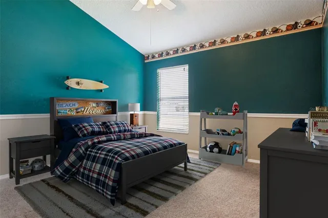 a bedroom with a bed and a painting on the wall