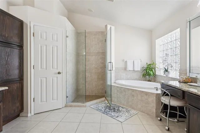 a spacious bathroom with a sink double vanity and a mirror