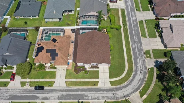 an aerial view of a house with swimming pool outdoor seating and yard