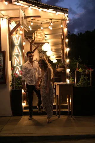 a view of a house with wooden fence