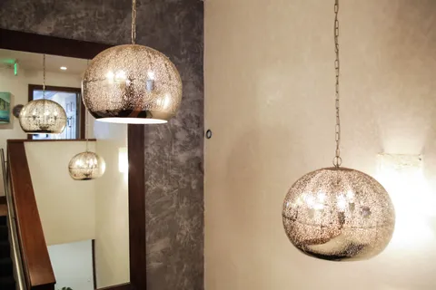 a living room with furniture flowerpot and wooden floor