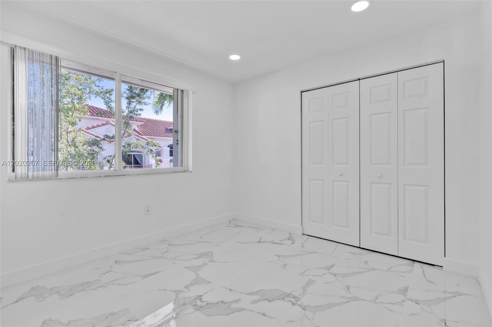 10245 Southwest 154th Place, Unit 1123 Miami, FL 33196 - Photo 19 of 38 a view of an empty room with a window