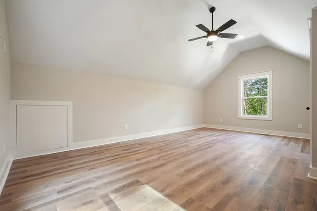 a front view of house with yard and trees around