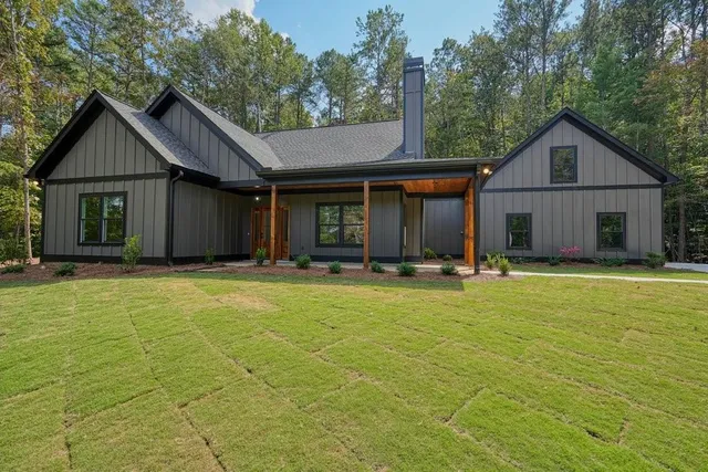 a view of an house with backyard space and a kitchen
