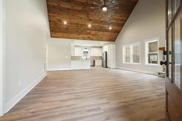 a view of empty room with wooden floor