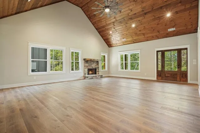 a view of a livingroom with wooden floor and windows