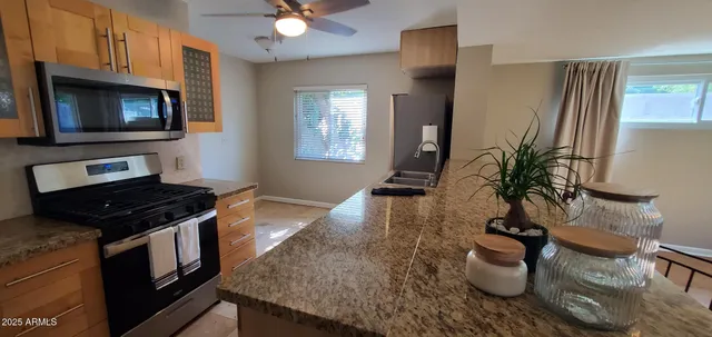 a kitchen with a stove a sink and a microwave