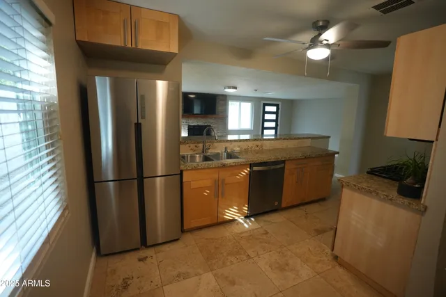 a kitchen with a refrigerator a microwave a stove and cabinets