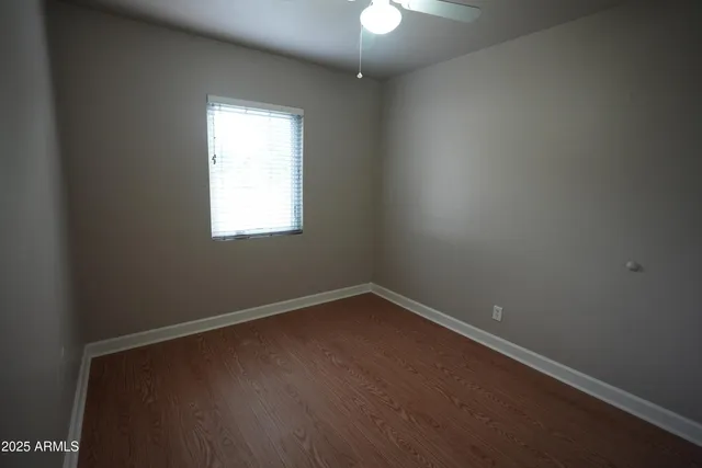 a view of empty room with fireplace and window
