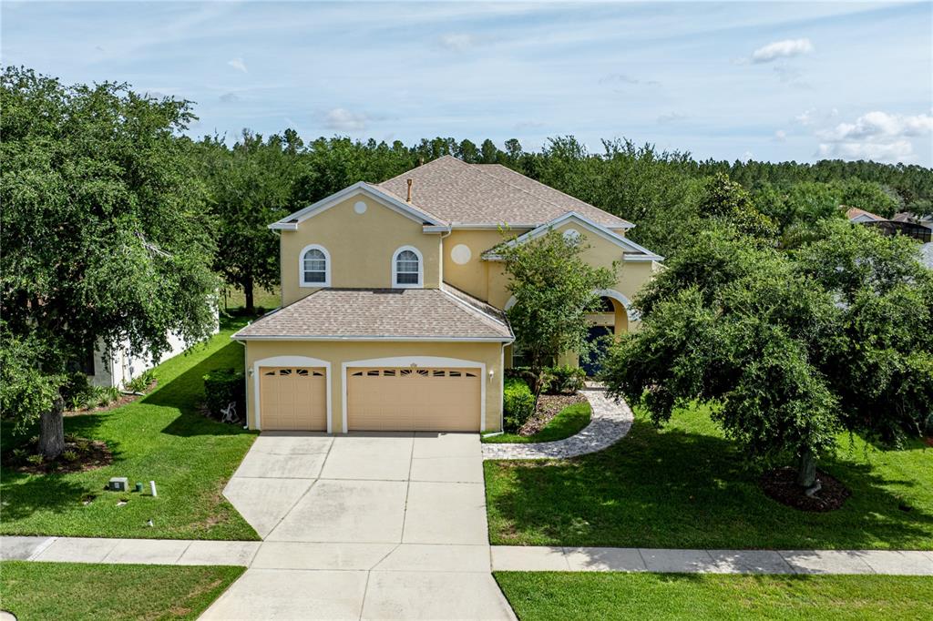 2718 Knightsbridge Road Clermont, FL 34711 - Photo 2 of 72 a front view of a house with a yard and trees