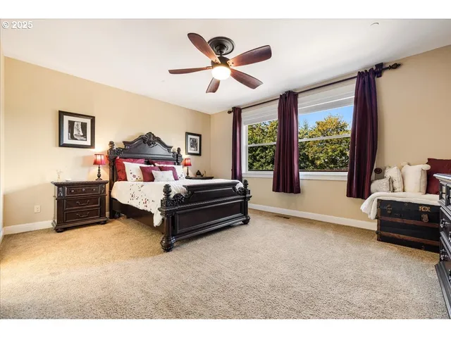 a bedroom with furniture and a large window