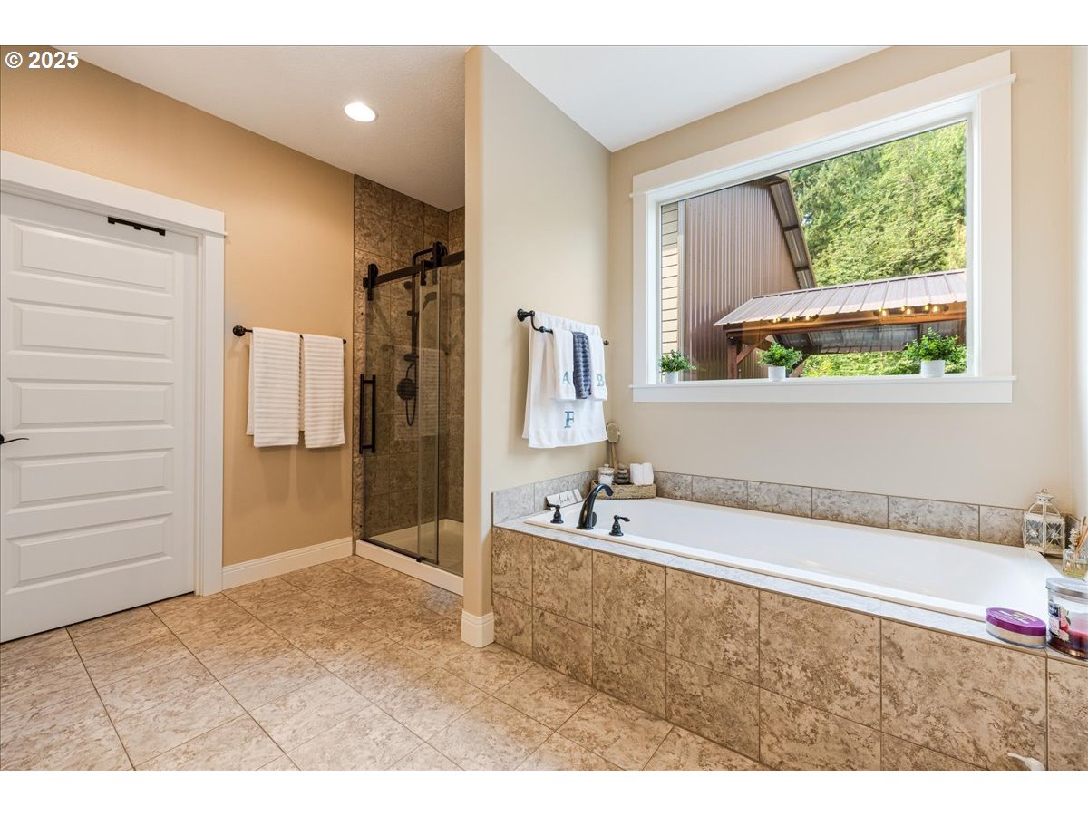 45632 Northwest Mead Way Banks, OR 97106 - Photo 15 of 48 a bathroom with a tub a sink and a window