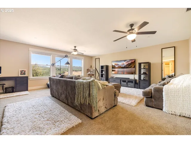 a living room with furniture and a kitchen view