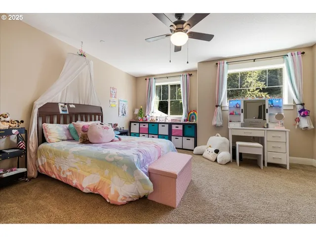 a bedroom with a bed couch and window