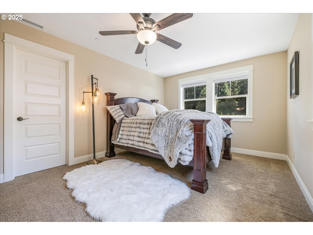 45632 Northwest Mead Way Banks, OR 97106 - Photo 20 of 48 a bedroom with a bed and a ceiling fan