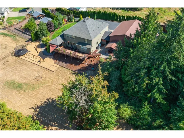 an aerial view of a house with yard swimming pool and outdoor seating