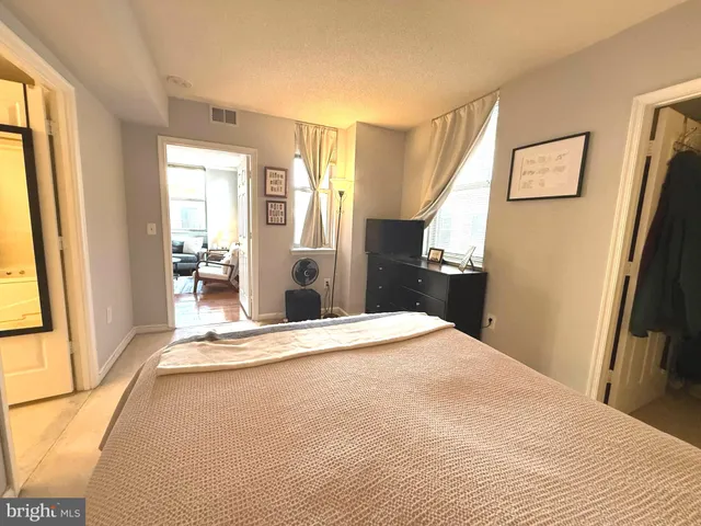 a bedroom with a bed and a walk in closet